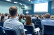© Victoriia - Audience attending business conference in modern auditorium, focused on speaker presentation. Professional learning environment.