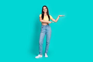 Poster - Full size photo of nice young woman point finger measure empty space wear top isolated on teal color background