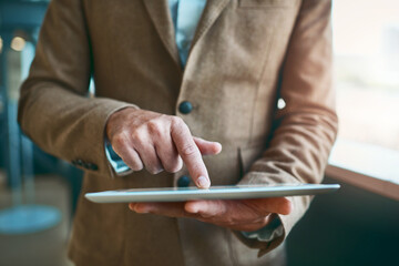 Poster - Businessman, hand and scroll on tablet in office for corporate research, company website and networking. Professional, employee and digital technology at work for email feedback or online information