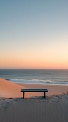 Wall Mural - Bench on sand dune overlooking ocean at