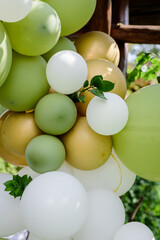 Wall Mural - Green, white and golden balloons on the party photo zone.