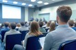 © Anton Gvozdikov - Diverse group of people attentively listening to speakers during a business seminar in modern conference room setting
