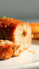 Poster - Closeup of a Savory Meatloaf Slice with Tangy Sauce