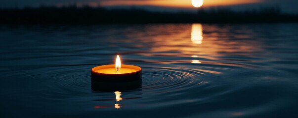 Poster - Floating candle on calm water at sunset