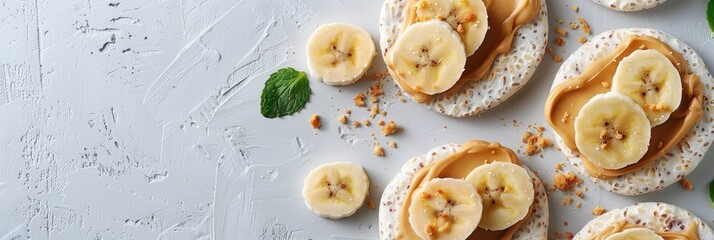 Poster - Nutritious rice cakes adorned with banana slices and peanut butter, viewed from above with ample blank space.