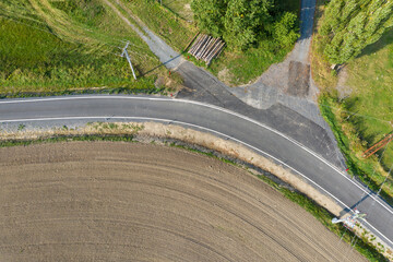 Asphalt road after laying asphalt. Black tarmac rebuilding. Roads in rural areas. 