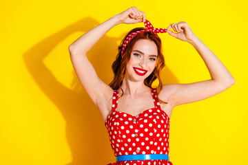 Wall Mural - Photo of cute lovely adorable lady wear red dotted clothes fixing head band isolated on vivid yellow color background