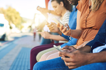 Aufkleber - Hands, phone and people waiting at bus stop in city for commute or public transport closeup. App, contact and social media with passenger group on sidewalk outdoor together for mobile communication