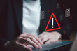 © BritCats Studio - Close up shot of people point to access to personal data and document with warning sign as concept of data breach or attack from hacker or spyware. Data security concept.