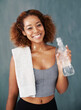 © peopleimages.com - Yoga, sweaty or portrait of happy woman with water, fatigue or resilience for fitness, wellness or healthy routine. Relax, tired or girl resting in pilates, club or break with bottle for hydration