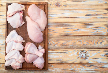 Poster - Raw mixed chicken meat parts  for cooking on rustic background