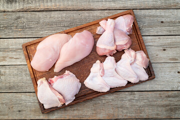 Wall Mural - Raw mixed chicken meat parts  for cooking on rustic background