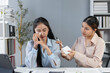 © amnaj - Manager comforts sad colleague at office desk, showcasing empathy and support in the workplace. Colleagues show sensitivity and understanding, highlighting compassion and teamwork