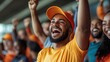 © nunoi - Cheerful sports fan celebrating at a game, exuding joy and team spirit in vibrant orange attire.