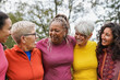 © Sabrina - Group of multi generational women hugging each other at city park - Community and multiracial people concept - Focus on african woman face