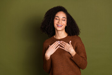 Poster - Portrait of pretty young woman hands chest laugh wear sweater isolated on khaki color background