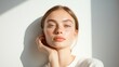 © DigitalMagicVisions - Serene Finnish Fashion Model in Minimalist Attire Bathed in Soft Sunlight with Poised Expression Against White Wall - Selective Focus Overlay