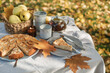 © RooM The Agency - Close-up of an apple pie and tea with a basket of apples on an autumnal garden table in the sun