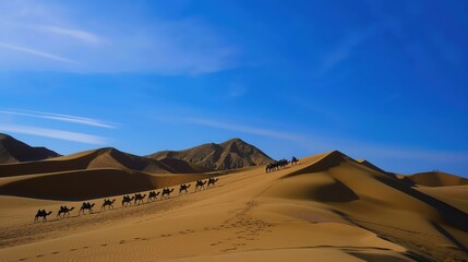 Camel caravan crossing golden sand dunes under clear blue sky, desert landscape and adventure travel