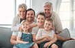 © DavisShared/peopleimages.com - Living room, portrait and big family with children on sofa for weekend fun, enjoyment and bonding together. Parents, happy and relax with generations at home for support, connection and love of kids