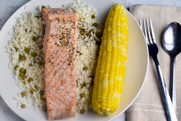 Wall Mural - baked salmon served with rice and corn