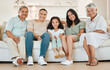© peopleimages.com - Happy, hug and portrait of child with grandparents on sofa for bonding, connection or care in home. Smile, love and girl kid embracing senior man and woman in living room of family house in Mexico.