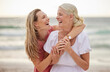 © Lumeez23/peopleimages.com - Smile, beach and senior mom with daughter for bonding holiday, love and embrace on weekend travel. Nature, mother and woman laughing on ocean adventure together with hug, fun and island vacation.