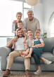 © DavisShared/peopleimages.com - Happy, people and portrait of big family on sofa for weekend enjoyment, fun and bonding together. Home, parents and relax with generations in living room for support, connection and love of children