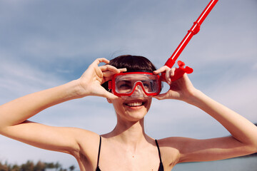 Wall Mural - Cheerful Woman Snorkeling in Red Fashionable Swimsuit, Smiling and Looking at Camera on a Tropical Beach