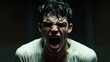 © DZMITRY - In a dark background, a grown man screams in portrait expression.
