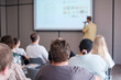 © Anton Gvozdikov - Group of people attending educational seminar focused on speaker presenting digital content on screen