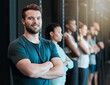 © Haas/peopleimages.com - Fitness, happy man and confident in gym class for portrait, wellness and ready for physical activity. Arms crossed, personal trainer and determined in sports club for training, workout and exercise