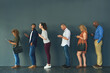 © TamJam/peopleimages.com - Bank, line and people waiting with technology for account, withdrawal and service at branch. Customer experience, client and diversity with phone in queue for finance, transaction and balance check