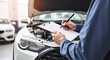 © Marco Mamdouh - Car check, car auto service concept. Mechanic engineer writing checklist for car services to estimate repair machine, inspecting maintenance by engineer at vehicle garage