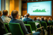 © alisluch - Audience attending a conference with a presentation on a large screen showing a bar chart, representing business or educational seminar