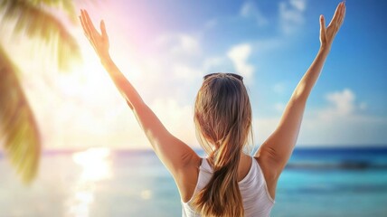 Canvas Print - A woman is standing on a beach with her arms raised in the air