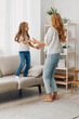 © SHOTPRIME STUDIO - Joyful mother and daughter bonding and playing on the living room floor, enjoying quality family time at home