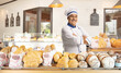 © Ljupco Smokovski - Mature male chef in a uniform posing with crossed arms in a bakery