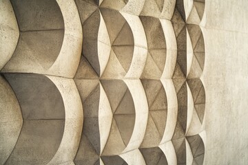 Poster - this closeup features a wall adorned with textured geometric patterns set against a smooth, muted ba