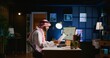 © DC Studio - Muslim teleworker crosschecking analytics statistical data set with paperwork while remotely working in dimly lit apartment office. Hardworking Arab employee optimizing key performance indicators