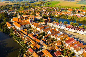 Wall Mural - View from drone of historical houses and town square of small Czech city Telc surrounded by ponds in sunny fall day