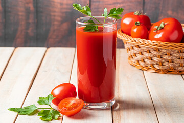 Diet tomato juice with parsley on a wooden background. Vegan vegetable smoothie.