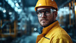 © Rabiyah - Engineer with Glasses and Yellow Attire, Representing Growth and Ambition in a Factory
