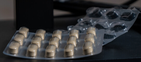 Poster - A pack of pills is on a table