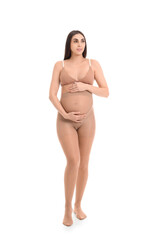 Sticker - Young pregnant woman in tights on white background