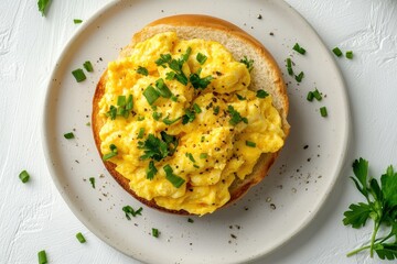 Canvas Print - Nutritious breakfast of scrambled eggs on a bun top view