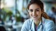 © Siasart Stock - A smiling female doctor in a medical setting, wearing a stethoscope.