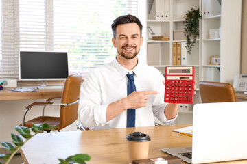 Canvas Print - Male accountant pointing at calculator in office