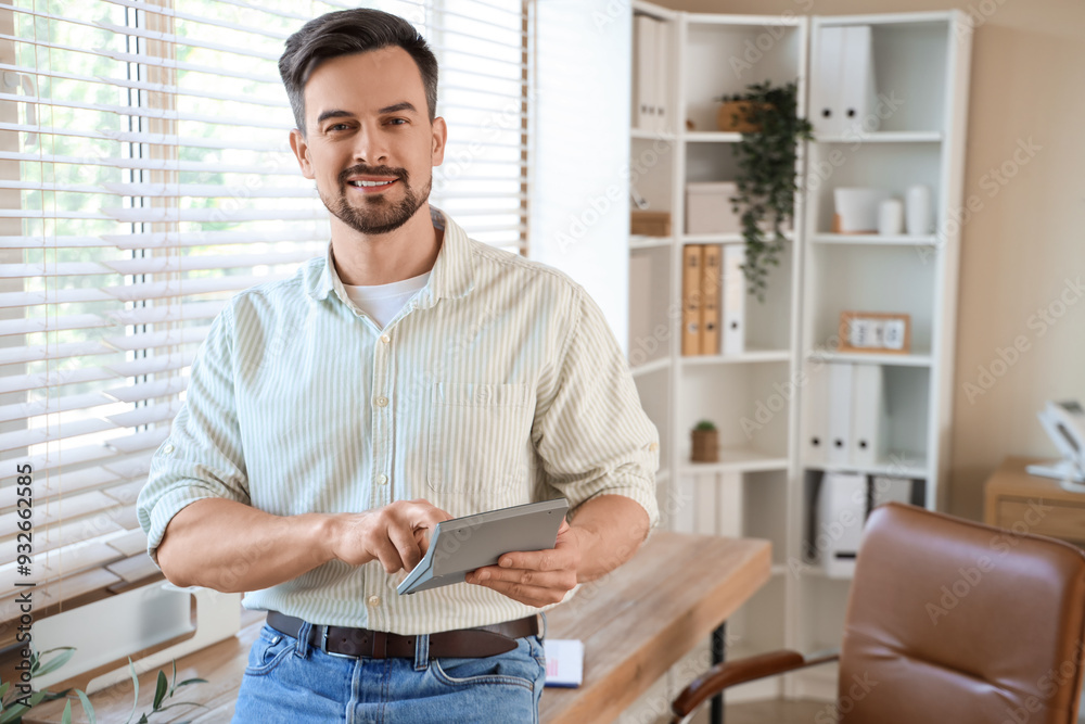 Male accountant working with calculator in office