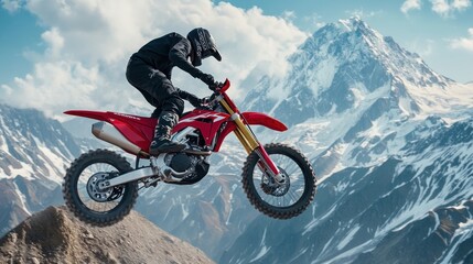 Motocross Rider Soaring Through Mountainous Terrain